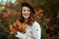 Smiling elegant 40 years old woman in beige trench coat