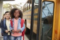 Smiling elementary school kids queueing for the school bus Royalty Free Stock Photo