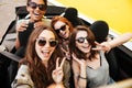 Smiling emotional four young women friends sitting in car Royalty Free Stock Photo