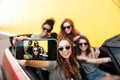 Smiling emotional four young women friends sitting in car Royalty Free Stock Photo