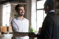 Smiling employee handshaking with executive, getting job or reward Royalty Free Stock Photo