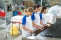 Smiling employee the ironing