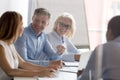 Smiling employees brainstorm sharing ideas at briefing Royalty Free Stock Photo