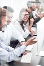 Smiling employees of call center talk sitting behind a Desk Royalty Free Stock Photo