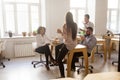 Smiling employees enjoying pizza having shared lunch break in of Royalty Free Stock Photo