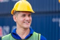 Smiling engineer in hard hat with containers box background, Portrait of Cheerful dock worker man at containers cargo, Logistic Royalty Free Stock Photo