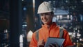 Smiling engineer inspecting inventory industrial facility with tablet closeup. Royalty Free Stock Photo