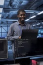 Smiling engineer pleased by recovery plan, monitoring data center