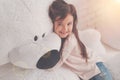 Smiling enthusiastic child hugging her fluffy bear Royalty Free Stock Photo