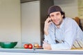 Smiling entrepeneur making a phone call in his takeaway food sta Royalty Free Stock Photo