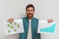 Smiling entrepreneur or salesman showing charts sales and business plan on white background Royalty Free Stock Photo