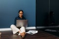 Smiling entrepreneur sitting on the floor