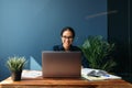 Smiling entrepreneur sitting at home working