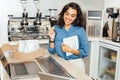 Smiling entrepreneur woman standing at a table