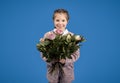 Smiling european little girl with bouquet of flowers enjoy spring birthday