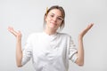 European student woman in gesture of asking over gray background Royalty Free Stock Photo