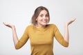 European student woman in gesture of asking over gray background Royalty Free Stock Photo