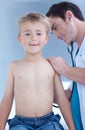 Smiling examinating a child with stethoscope