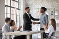 Smiling executive congratulating African American employee, shaking hands Royalty Free Stock Photo