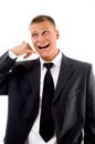 Smiling executive showing telephonic gesture Royalty Free Stock Photo