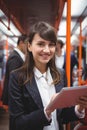 Smiling executive using digital tablet in train Royalty Free Stock Photo