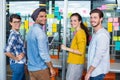 Smiling executives discussing over sticky notes on glass wall Royalty Free Stock Photo