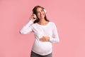 Smiling Expectant Girl In Headphones Listening To Song, Studio Shot Royalty Free Stock Photo