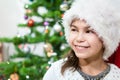 Smiling face on young pretty girl in white Santa hat, copy space Royalty Free Stock Photo