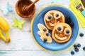 Smiling faces on pancakes with fresh fruit for kids Royalty Free Stock Photo