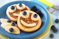 Smiling faces on pancakes with fresh fruit for kids Royalty Free Stock Photo