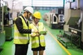 Smiling factory team discuss machine audit by tablet