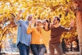 Smiling family on an autumns day in park make selfie