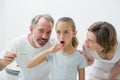 Smiling family brushing their teeth with toothbrush