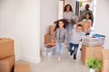 Smiling Family Carrying Boxes Into New Home On Moving Day Royalty Free Stock Photo