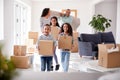 Smiling Family Carrying Boxes Into New Home On Moving Day Royalty Free Stock Photo