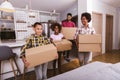 Family carrying boxes into new home on moving day Royalty Free Stock Photo