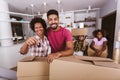 Family carrying boxes into new home on moving day, holding keys in new apartment Royalty Free Stock Photo