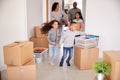 Smiling Family Carrying Boxes Into New Home On Moving Day Royalty Free Stock Photo