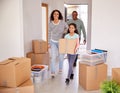 Smiling Family Carrying Boxes Into New Home On Moving Day Royalty Free Stock Photo