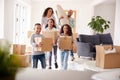 Smiling Family Carrying Boxes Into New Home On Moving Day Royalty Free Stock Photo