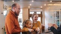 A smiling family checking in the hotel - standing by the reception Royalty Free Stock Photo