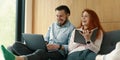 Smiling family couple spending time together, laughing, using laptop Royalty Free Stock Photo