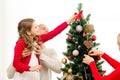 Smiling family decorating christmas tree at home Royalty Free Stock Photo