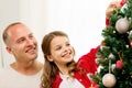 Smiling family decorating christmas tree at home Royalty Free Stock Photo