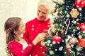 Smiling family decorating christmas tree at home Royalty Free Stock Photo