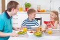 Smiling family eating breakfast in kitchen Royalty Free Stock Photo