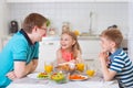 Smiling family eating breakfast in kitchen Royalty Free Stock Photo