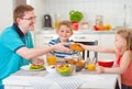 Smiling family eating breakfast in kitchen Royalty Free Stock Photo