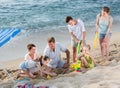 Smiling family with four children playing on sea beach Royalty Free Stock Photo