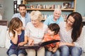 Smiling family with grandparents with photo album Royalty Free Stock Photo